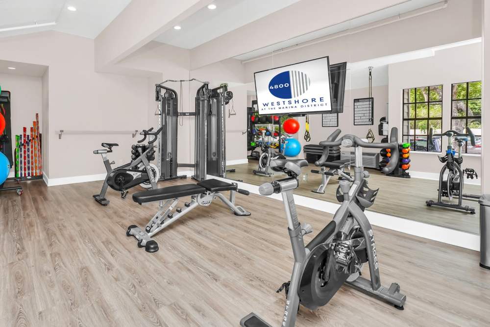 Yoga room with large mirror and workout equipment at 4800 Westshore in Tampa, Florida