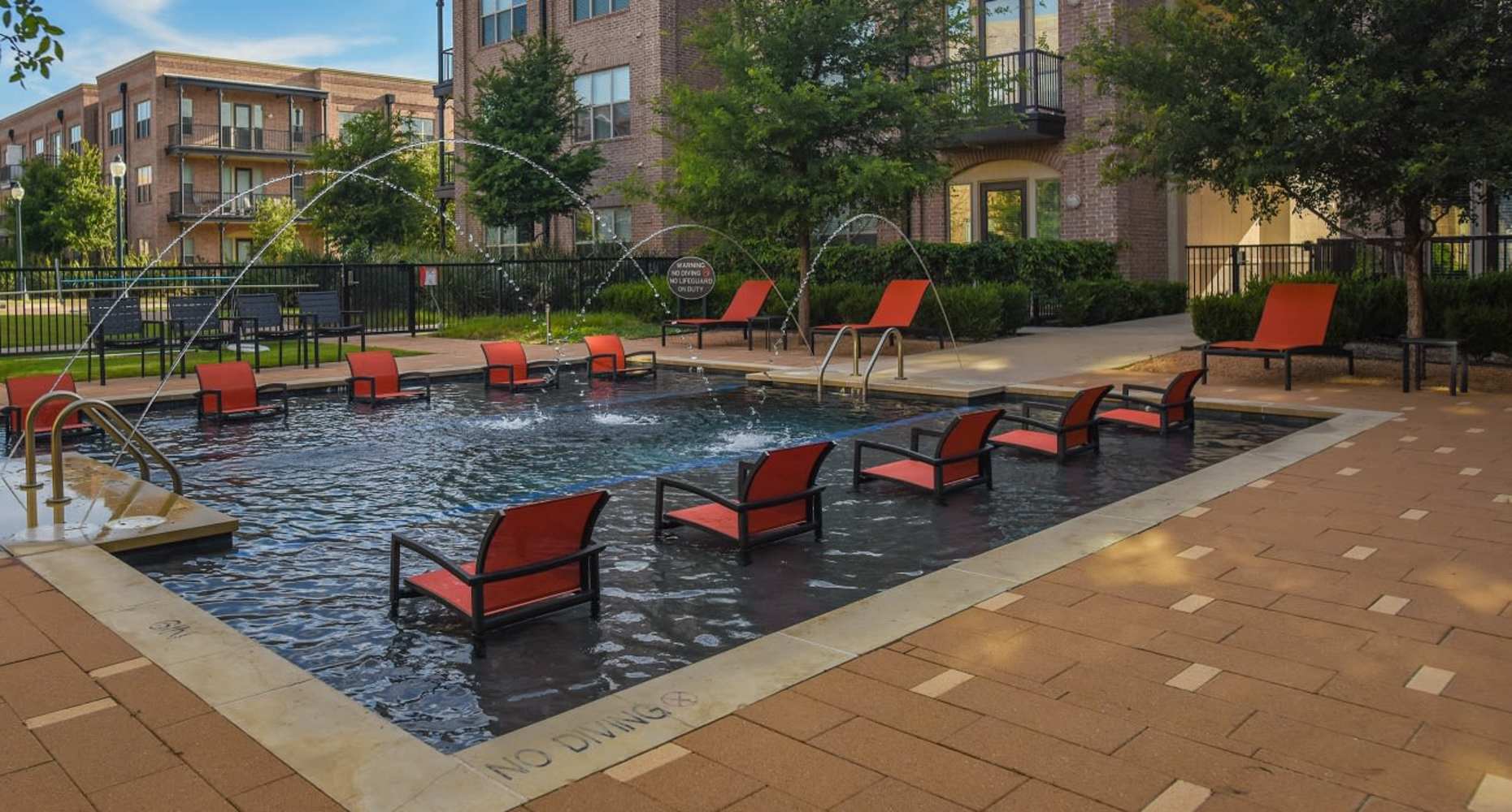 Resort-style pool and sundeck cabana at Flatiron District at Austin Ranch in The Colony, Texas