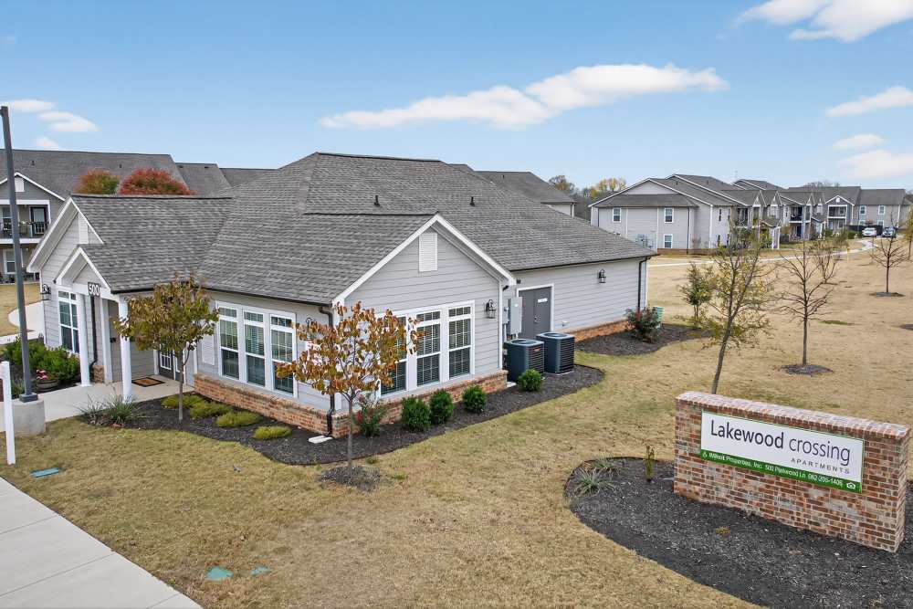 Charming community entrance featuring modern architecture and lush landscaping at Lakewood Crossing in Granbury, Texas