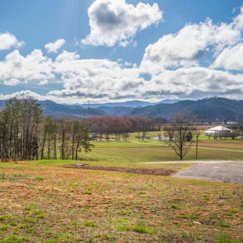 Scenic view of rolling hills and trees under a partly cloudy sky at Plainsview Greene in Tellico Plains, Tennessee