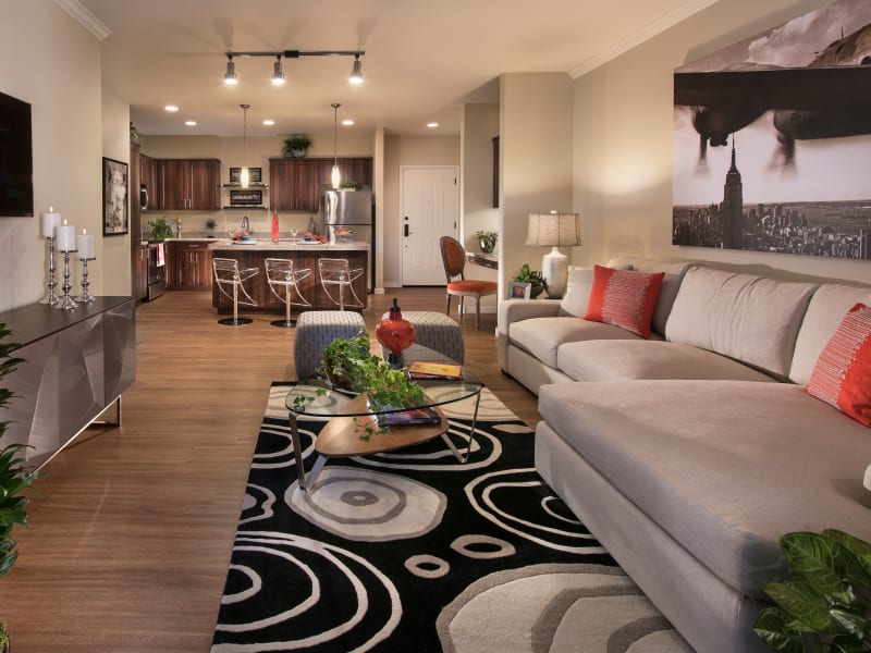 Well-furnished living area with hardwood flooring throughout in a model home interior rendering at Sobremesa Villas in Surprise, Arizona
