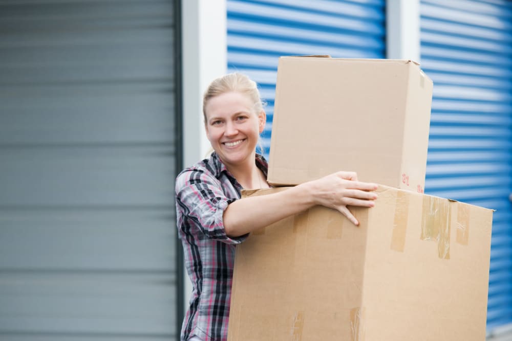A woman moving boxes out of a storage unit at StayLock Storage in Leesburg, Georgia