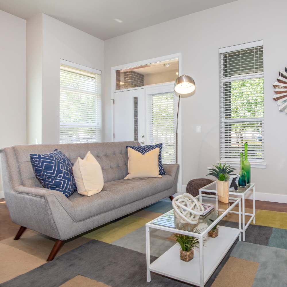 Living room with couch and large window at Park Place Olde Town Apartments in Arvada,Colorado