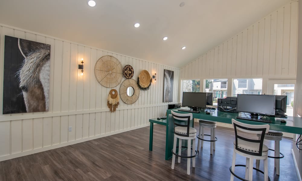 Elevated dining chairs with paintings on wall at Aspen Park Apartments in Wichita, Kansas