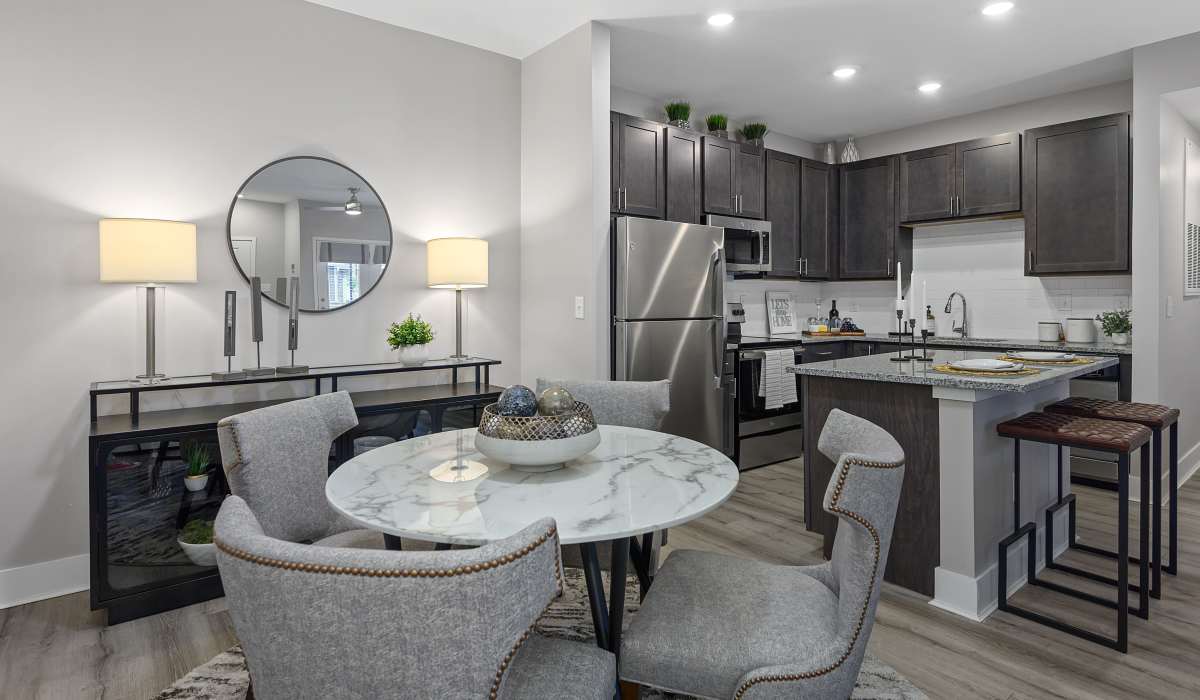 Modern kitchen with granite countertops and island at Gentry East Apartments in Cincinnati, Ohio