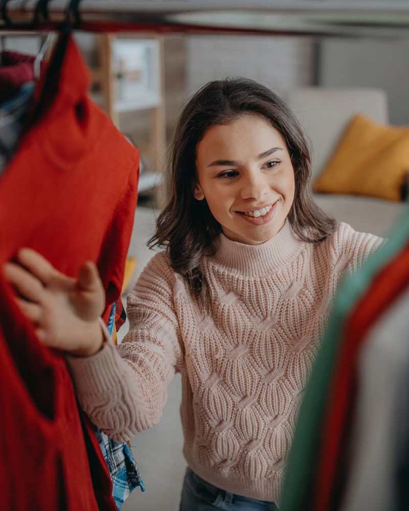 Resident picking clothes from a walk-in closet at Canyon Townhomes in Phoenix, Arizona
