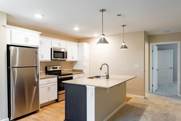 Kitchen with stainless-steel appliances at Bennington Hills Apartments in West Henrietta, New York