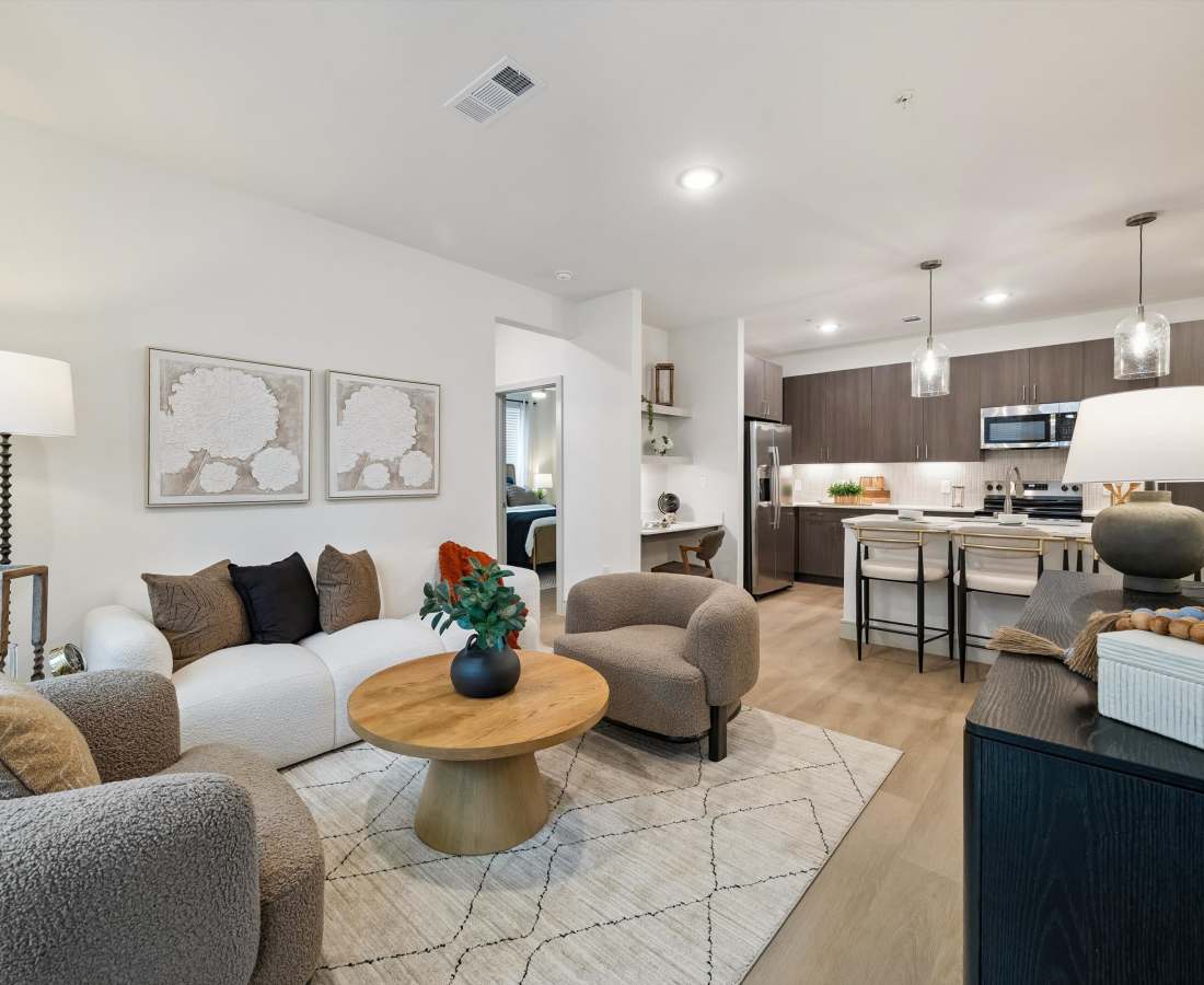 Modern round wooden coffee table with decorative items at Dakota at Hillcroft in Houston, Texas