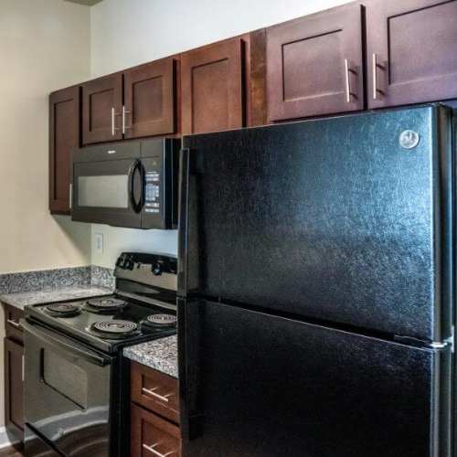 Kitchen with refrigerator and range at Commons at Fort Mill in Fort Mill, South Carolina