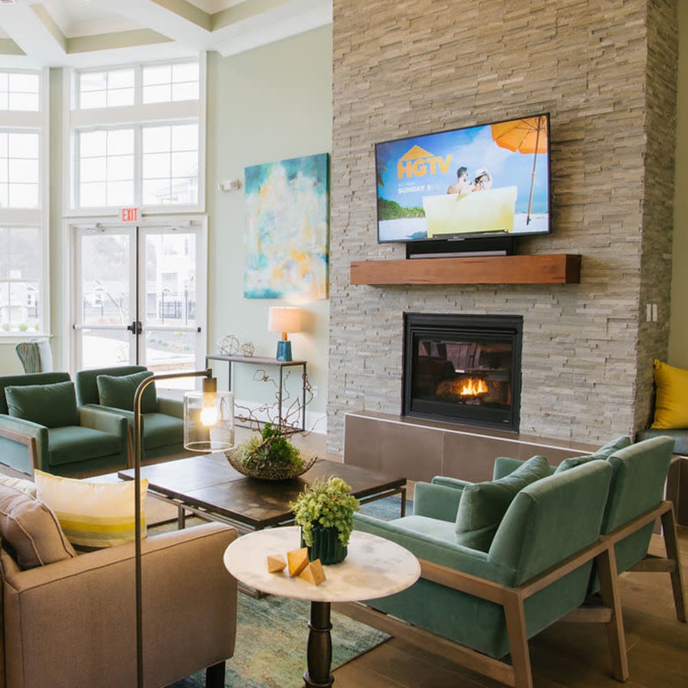 Clubhouse with fireplace and comfortable seating at Beacon on 5th in Charlottesville, Virginia