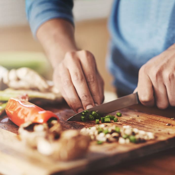 A resident chops vegetables in his kitchen at The Cascades, Virginia Beach, Virginia