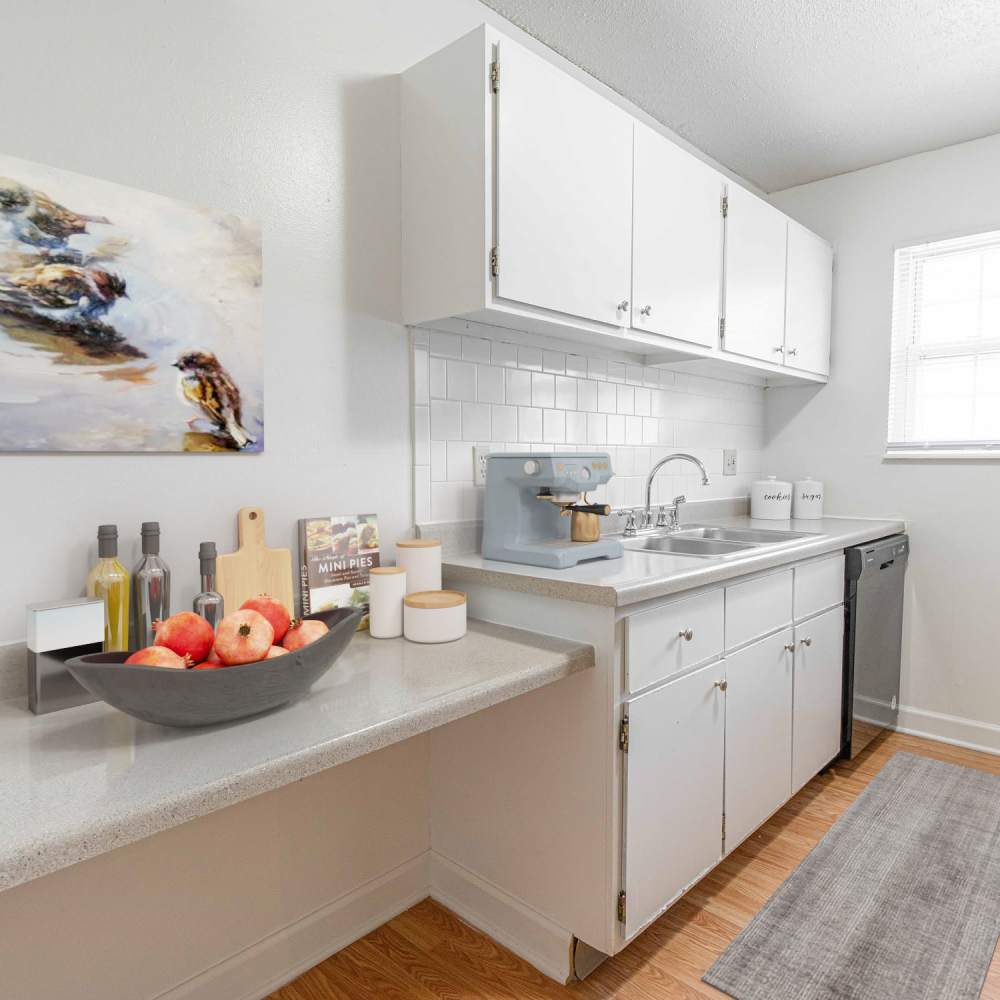 Kitchen with white appliances at Village Green Apartments in Chesterfield, Missouri
