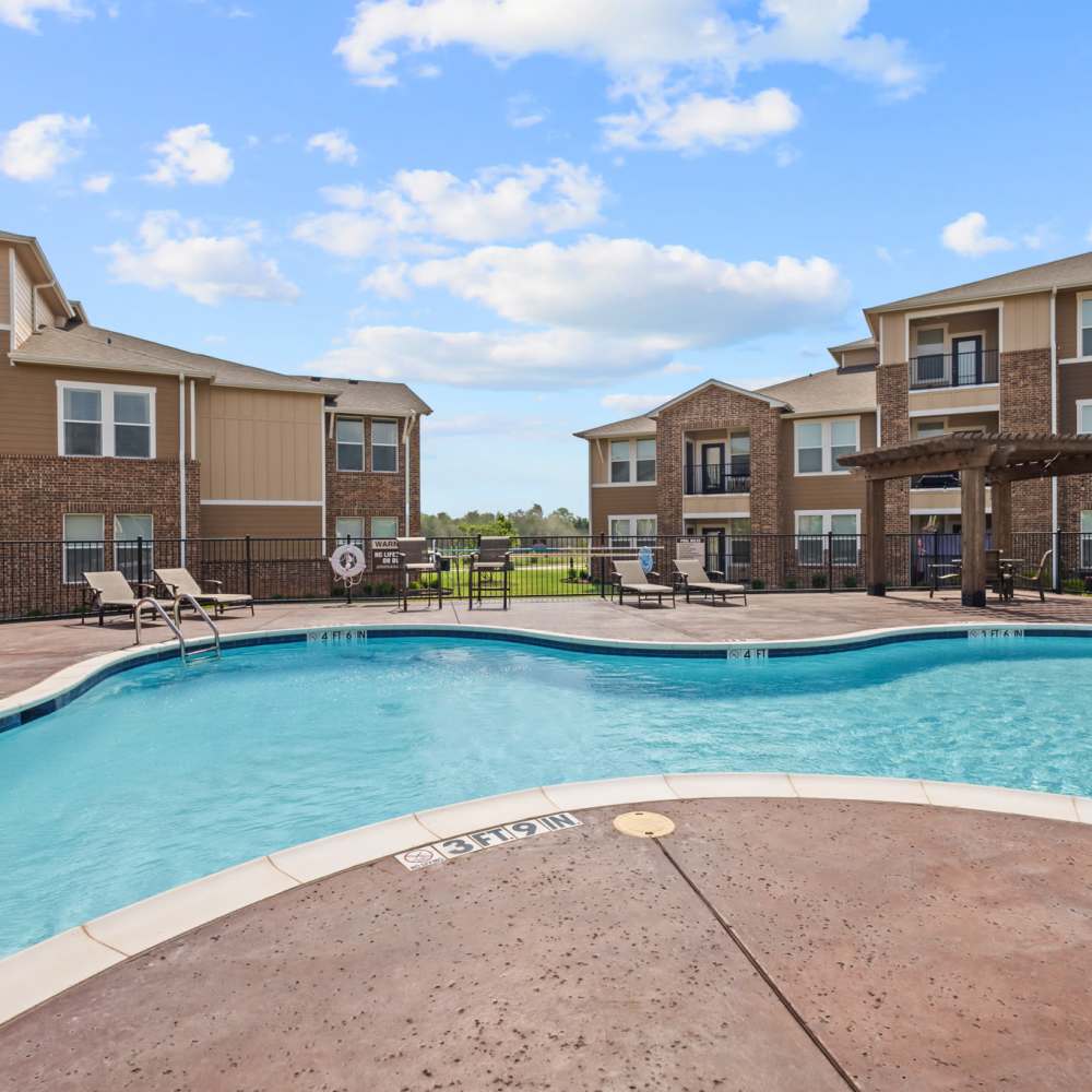 Swimming pool with lounge chairs at Deer Park in Athens, Texas