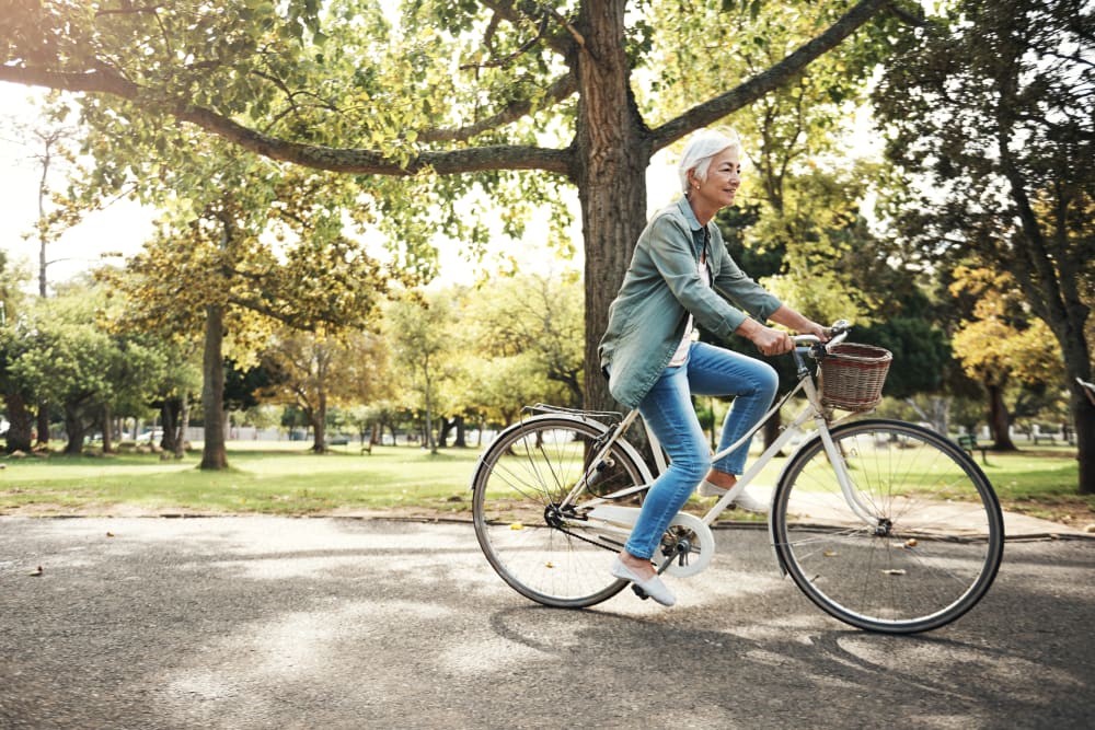 A woman on a bike ride near The Timbers Apartments in Hayward, California