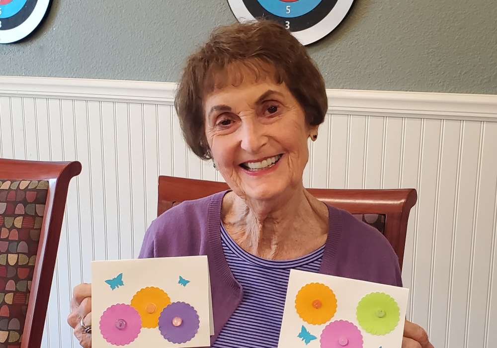Resident posing with birthday cards at The Pines, A Merrill Gardens Community in Rocklin, California