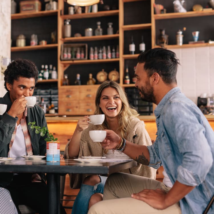 Group of friends enjoying some coffee together in a restaurant near Trails of Towne Lake in Irving, Texas