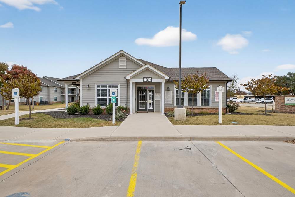 Charming community entrance featuring well-maintained landscaping at Lakewood Crossing in Granbury, Texas.