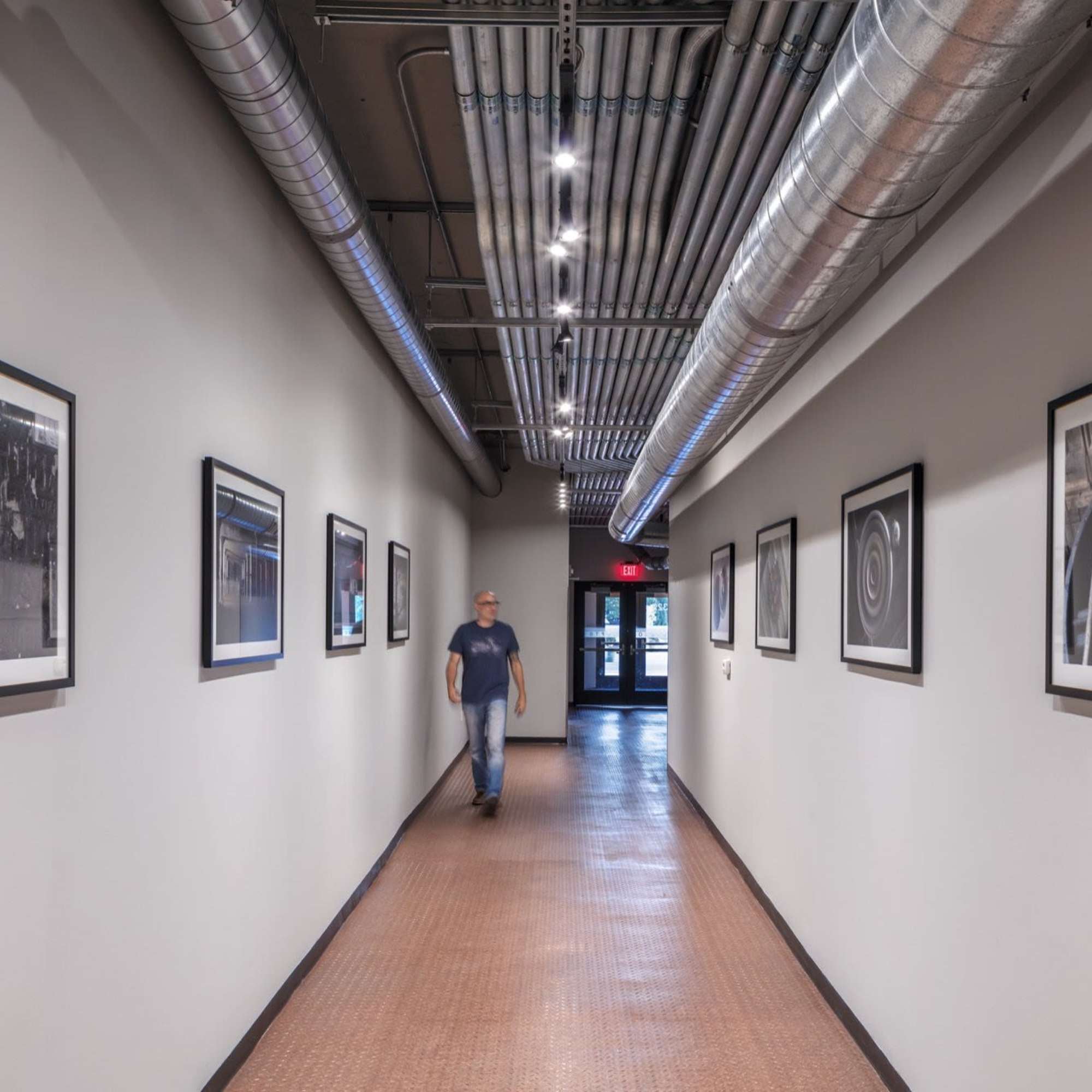 Resident walking in the lobby area at Delco Lofts in Dayton, Ohio