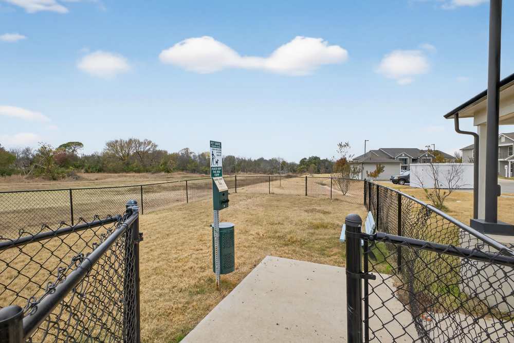 Expansive open lot with lush landscaping and a charming pet area at Lakewood Crossing in Granbury, Texas.