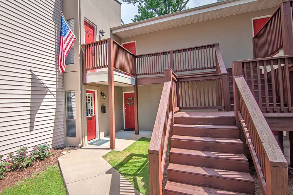 Wooden steps leading up to the entrance of the apartment at Milgen Village in Columbus, Georgia