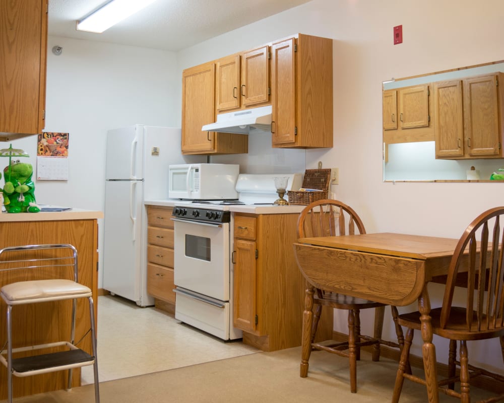 Resident apartment with a galley kitchen at Meadow Lakes Senior Living in Rochester, Minnesota.
