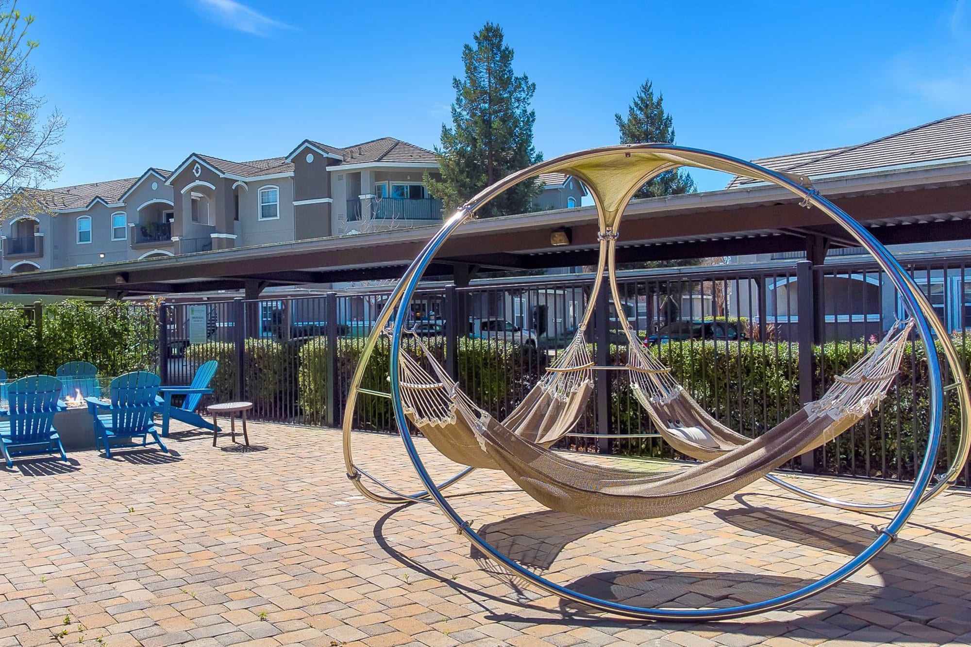 A firepit surrounded by Adirondack chairs at Hawthorn Village Apartments in Napa, California