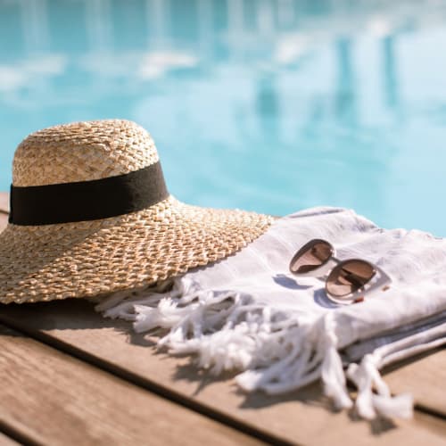 Hat and shades by the pool at Sonterra Heights in San Antonio, Texas