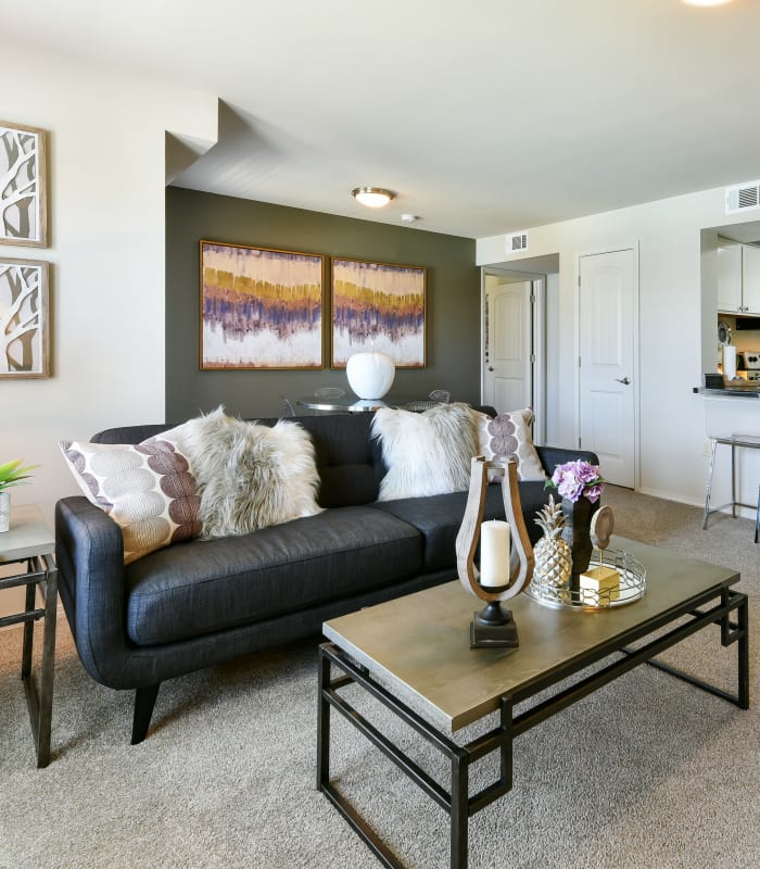 Carpeted living room at Cottages at Abbey Glen Apartments in Lubbock, Texas