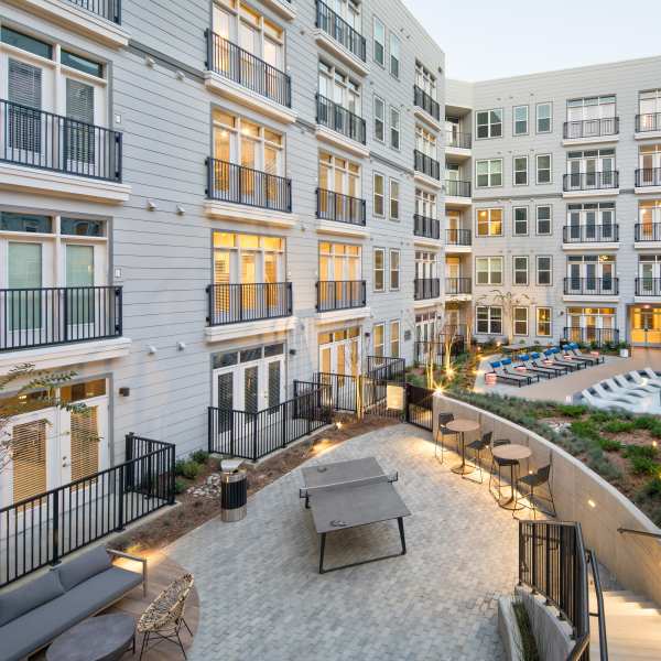 A courtyard with a ping pong table, seating areas near Vine North Hills in Raleigh, North Carolina
