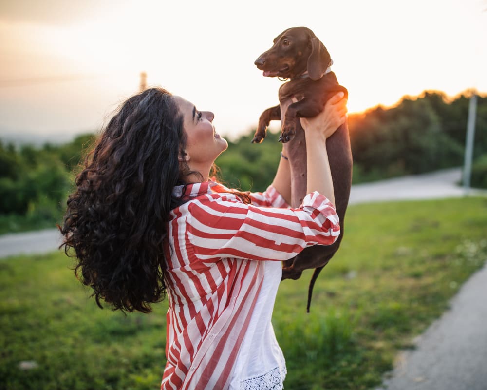 Resident with her dog outside of Eagle Pointe Apartment Homes in New London, Connecticut