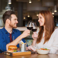 A happy couple having drink in restaurant near Discovery at Craig Ranch in McKinney, Texas