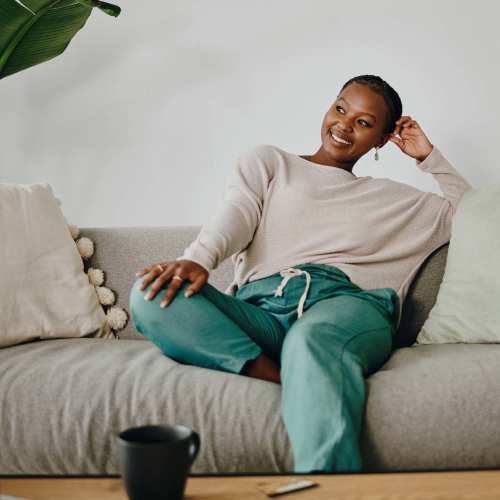 Woman resting in her living room at The View at Blue Ridge Commons in Roanoke, Virginia