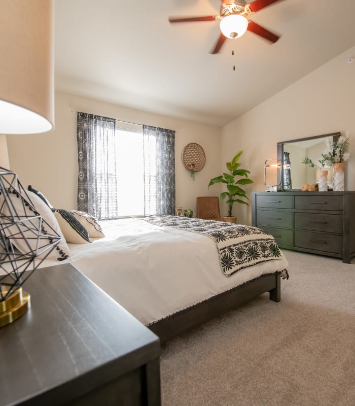 Spacious carpeted bedroom at Portico at Friars Creek Apartments in Temple, Texas