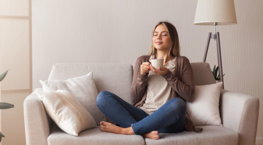 A resident relaxes with a cup of coffee in her apartment at Glenwood Pointe in Twinsburg, Ohio