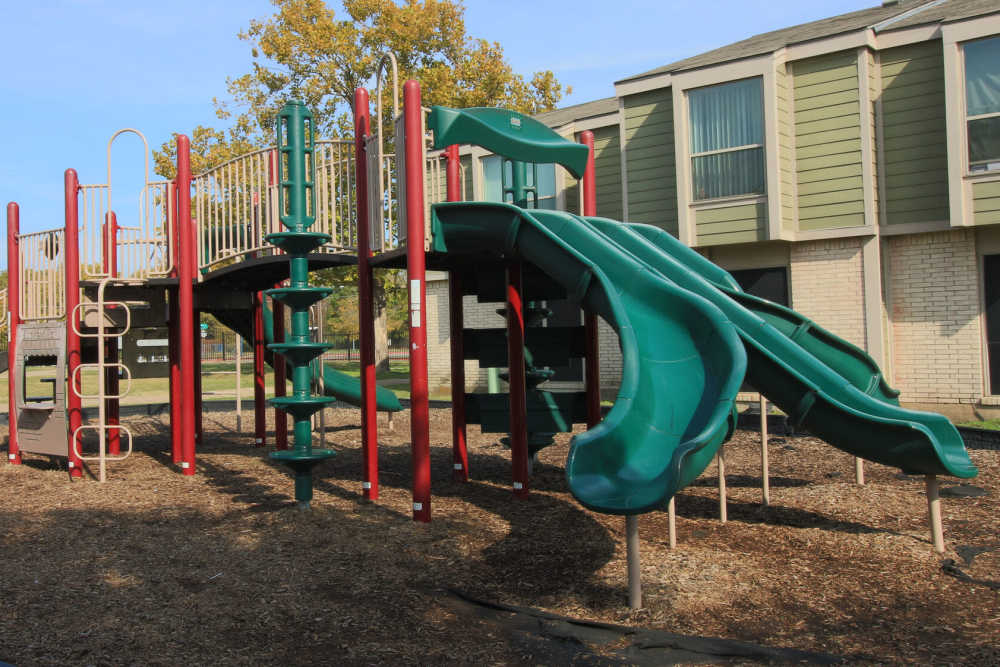 Playground with green and red slides at Cherokee Village in Dallas,Texas