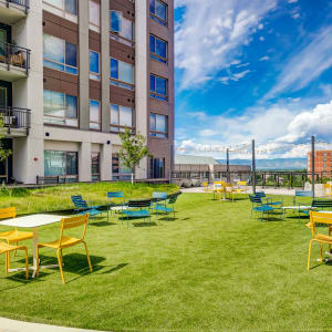 Outdoor seating on the lawn at Vue West Apartment Homes in Denver, Colorado