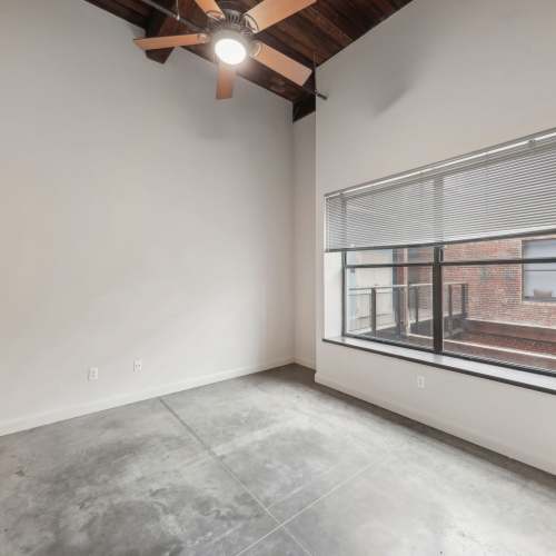 Unfurnished bedroom with large window at Stadium Loft Apartments in Saint Louis, Missouri