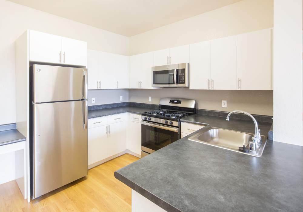 Kitchen with stainless-steel appliances at Park Hacienda Apartments in Pleasanton, California