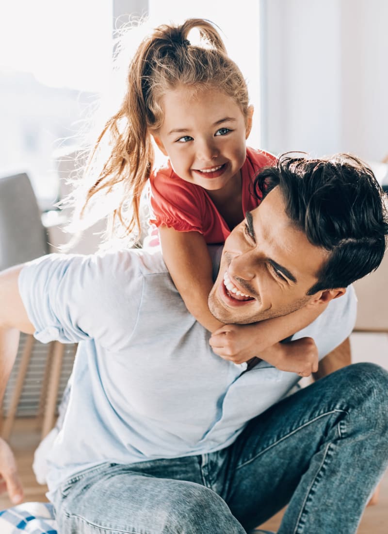 Resident playing with his daughter at Marquis at Sugar Land in Sugar Land, Texas