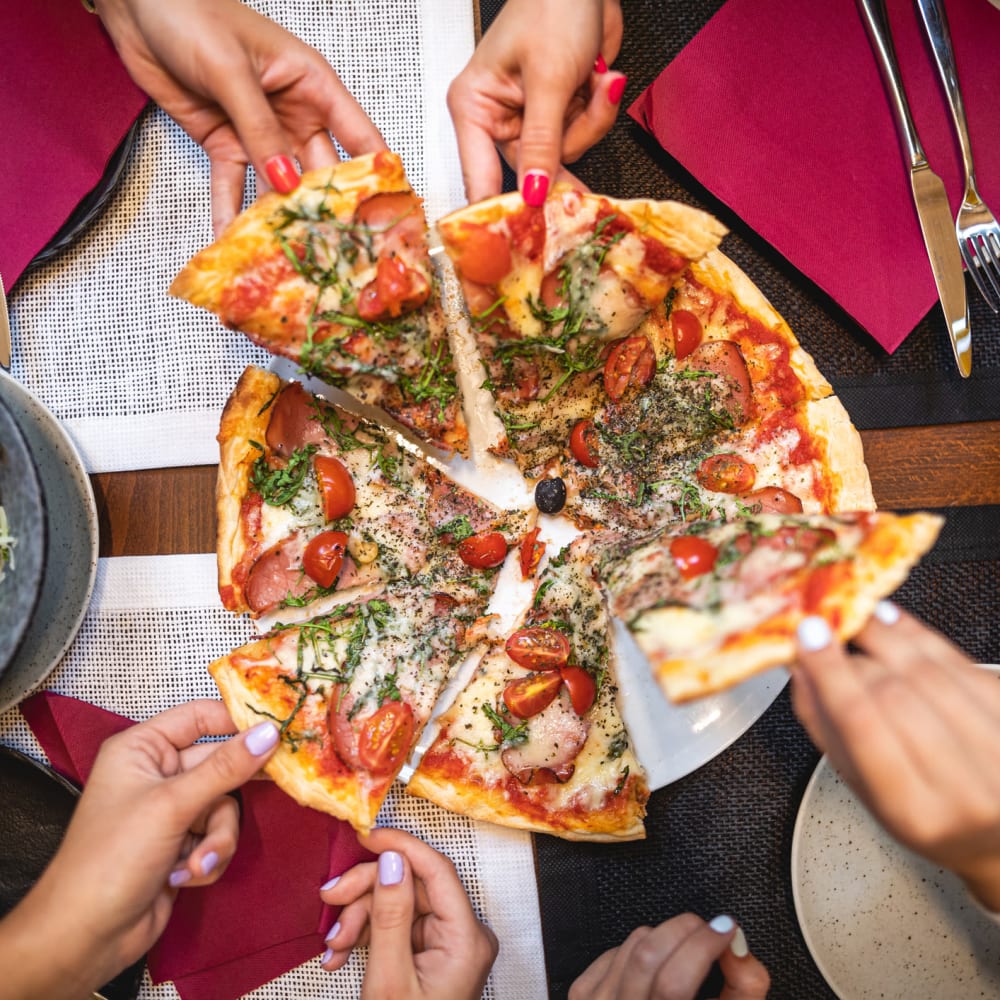 Delicious looking pizza being shared by friends at The Ivy in Tampa, Florida