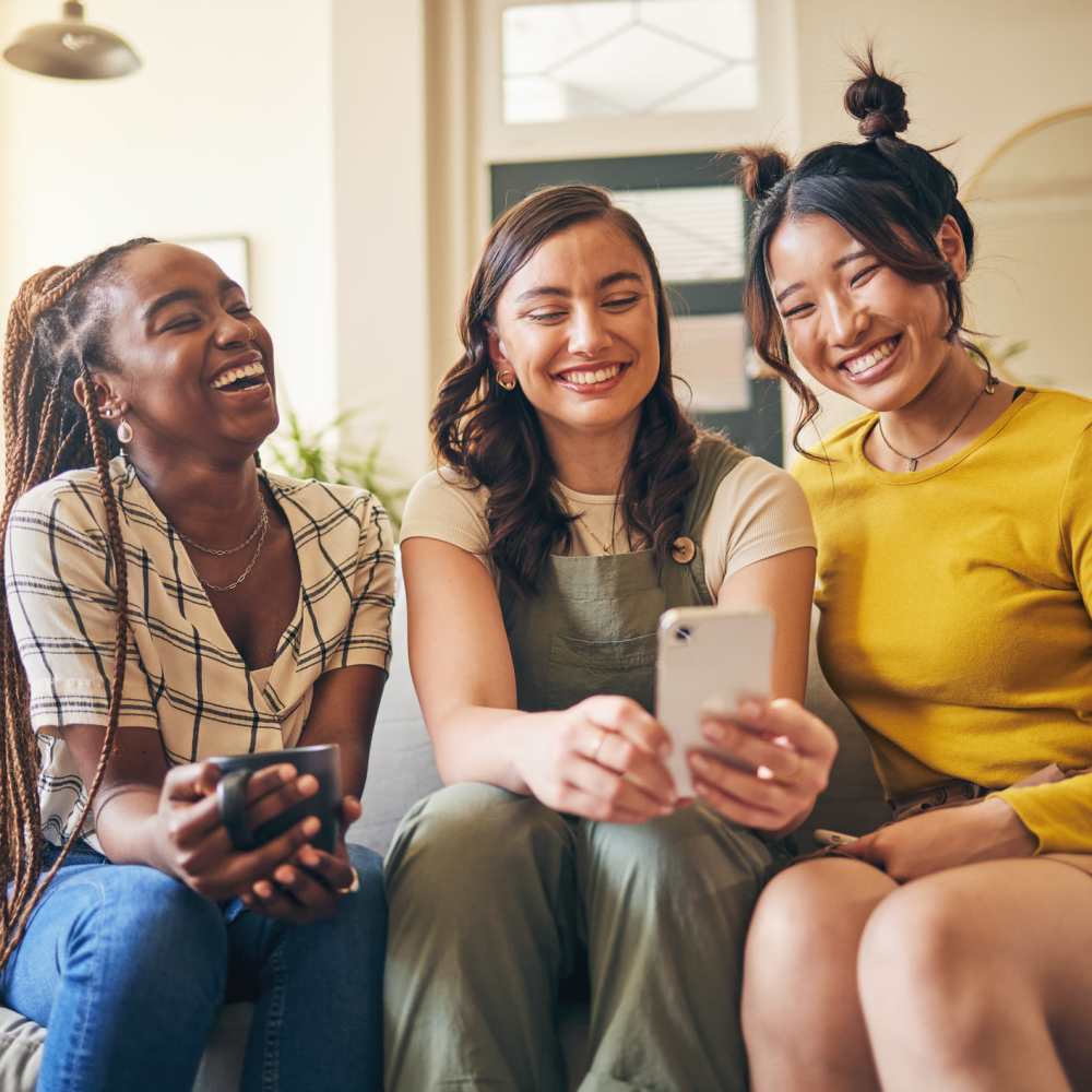 Women laughing together in living room at The Simone in Silver Spring, Maryland