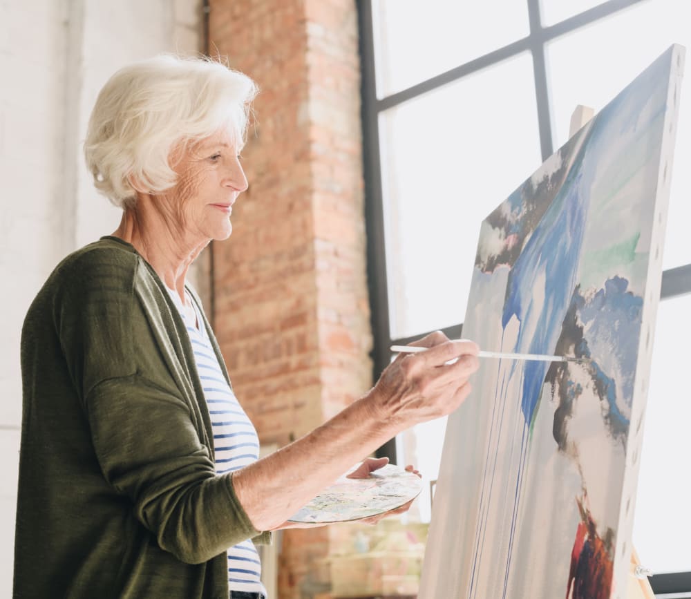 Woman resident painting at Clearwater at Rancharrah in Reno, Nevada