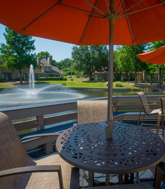 Deck seating with orange umbrella of Sheridan Pond in Tulsa, Oklahoma