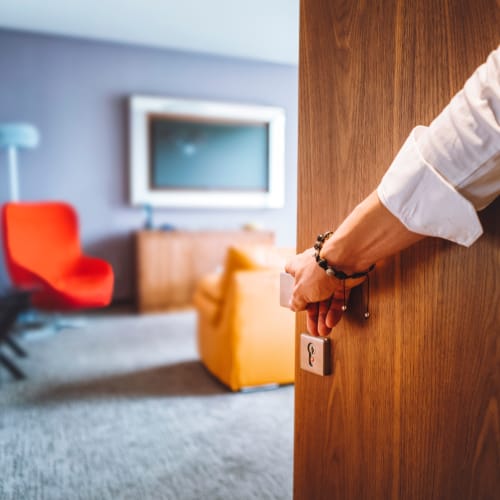 A resident opening the door at Castle Acres in Norfolk, Virginia