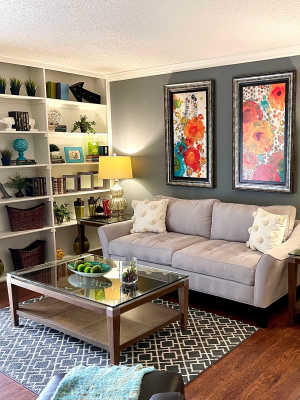 Living room with built-in bookshelf at The Abbey at Medical Center in San Antonio, Texas