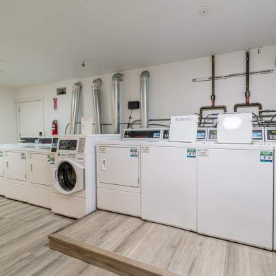 Resident on site laundry room Pinnacle Apartments in Fife, Washington