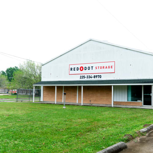 Exterior view of office building at Red Dot Storage in Baker, Louisiana with outdoor RV storage in the background