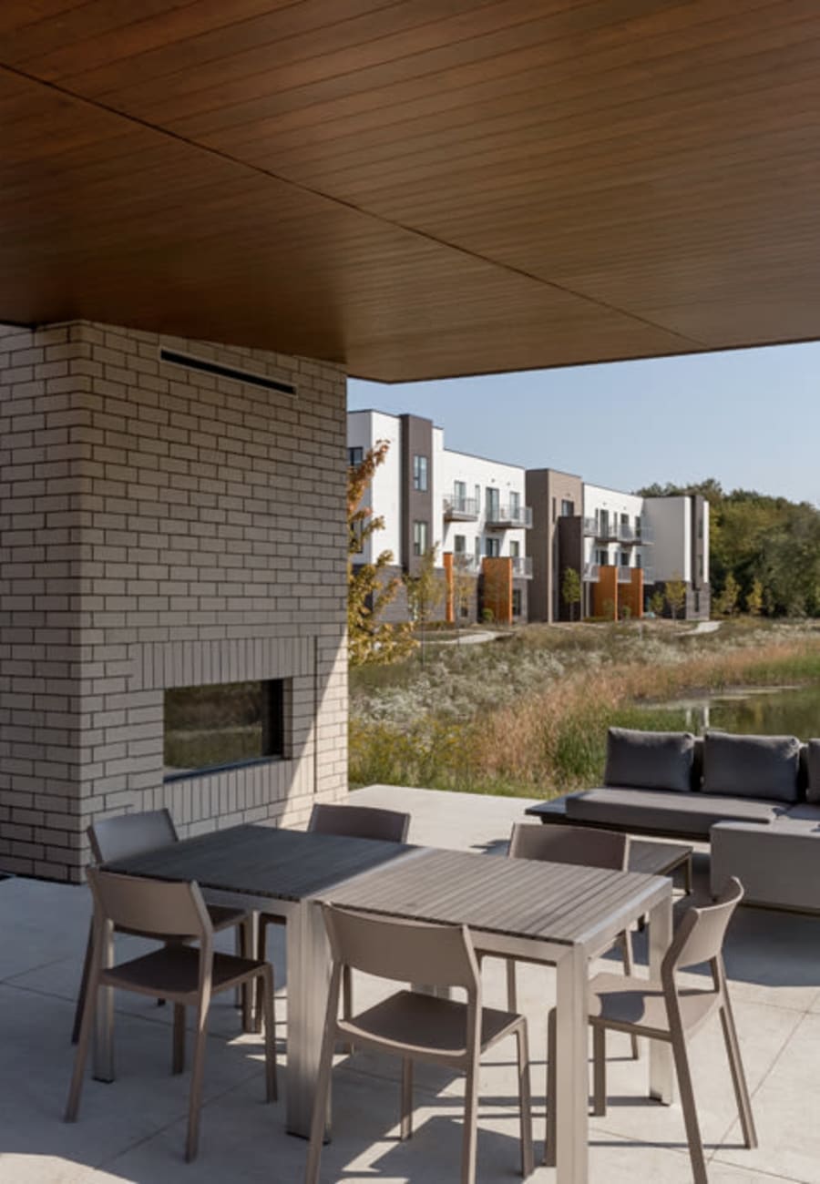 Outdoor patio area with a fireplace at Everton Flats in Warrenville, Illinois