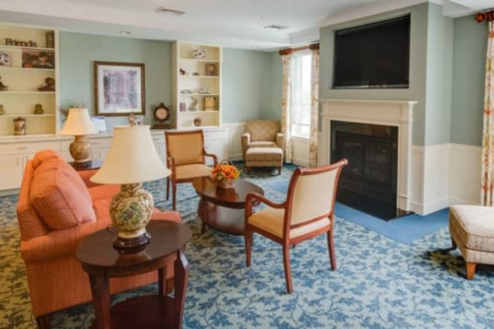 Cozy lounge area with fireplace at Victory Crest Apartments in Hyattsville, Maryland