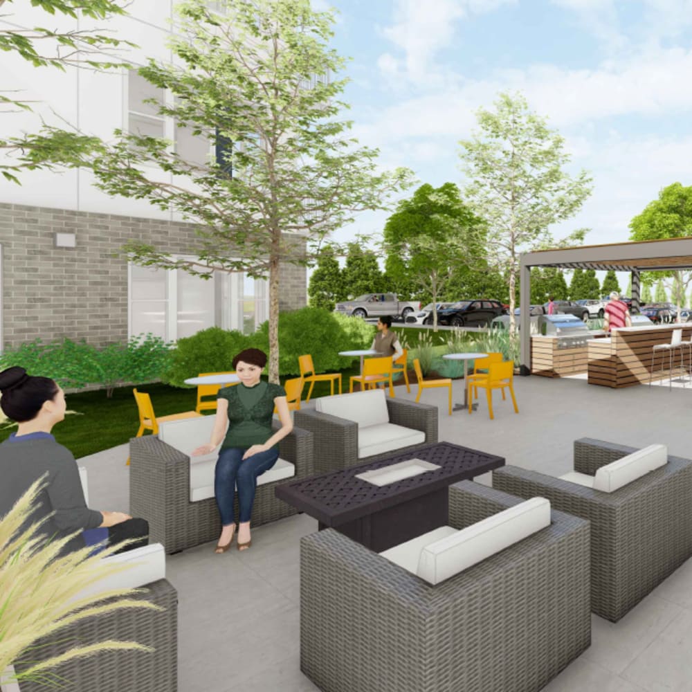 Stylish outdoor gathering space with fire pit seating, pavilion bar, and lush landscaping at The Intersect in Madison, Wisconsin